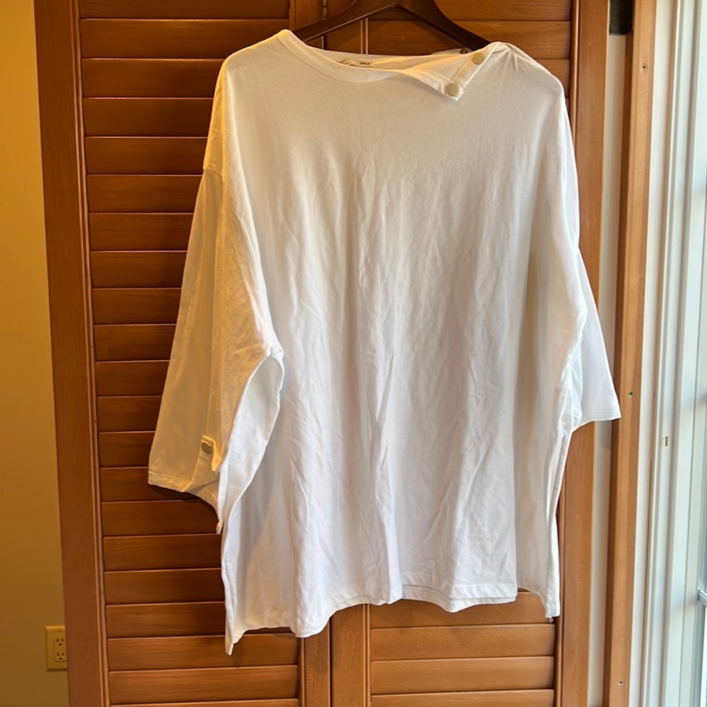 Oversized shirt with button detail at the neck line and arm area.